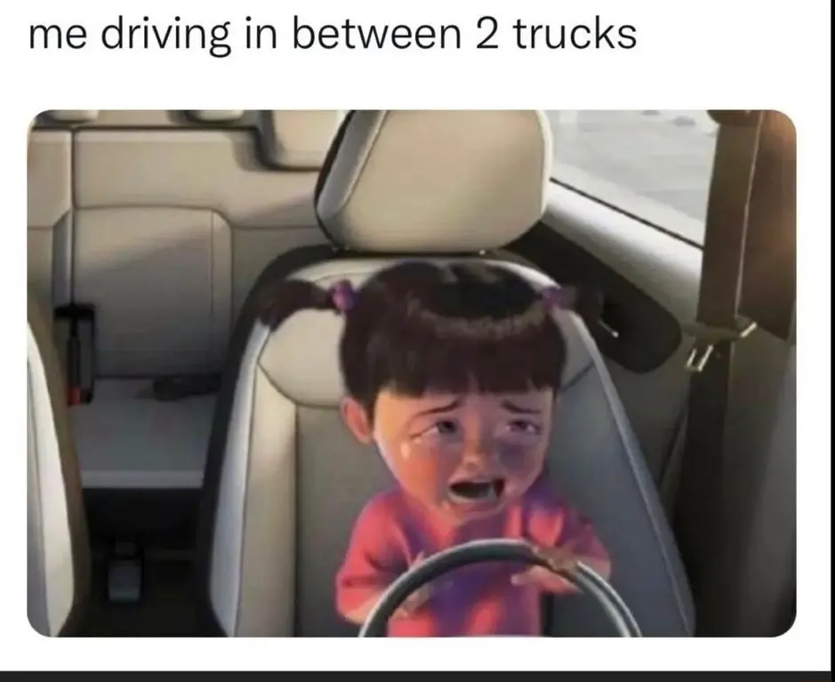 Crying boo meme driving between two trucks