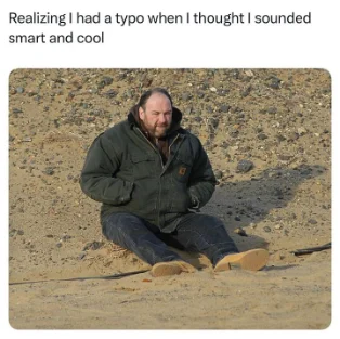 Realizing embarrassing typo meme sitting on sand